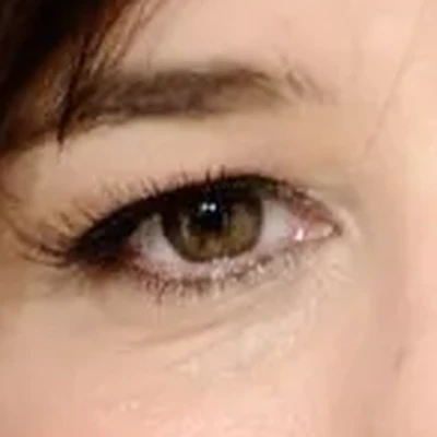 Parker Posey's eyes — olive-hazel green, muted and cool