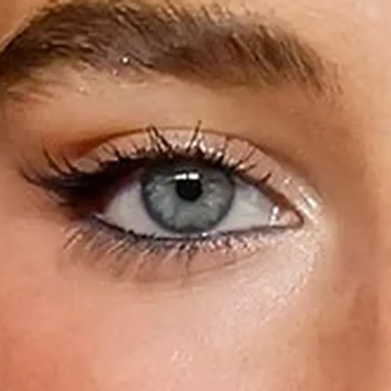 Sabrina Carpenter's eyes — clear blue-grey with bright Spring quality