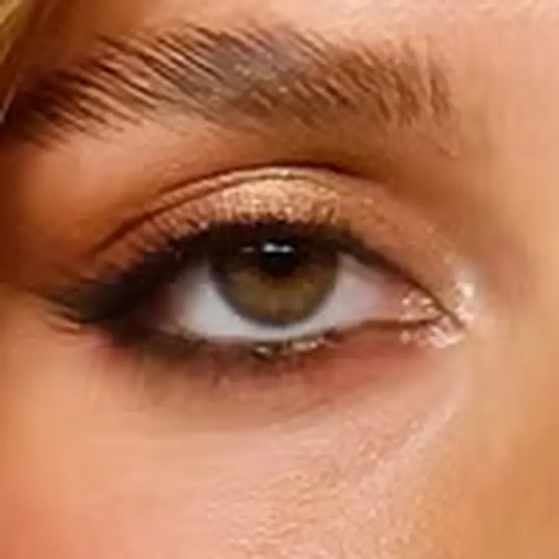 Tate McRae's eyes — warm olive-hazel with golden-brown tones